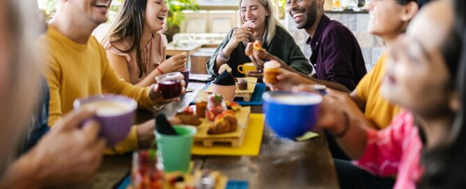 Multiracial people gathering together while having breakfast on rooftop cafe restaurant
