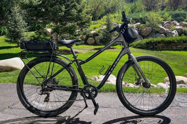 E-bike rental showcasing a sleek electric bike on a scenic path, surrounded by greenery, emphasizing outdoor exploration and casual riding experiences.