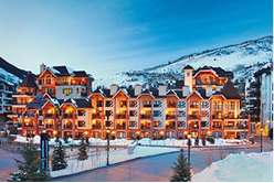 Marriott Mountain Valley Lodge in Breckenridge, Colorado, featuring a picturesque snowy landscape and illuminated exterior, highlighting ski rental services.