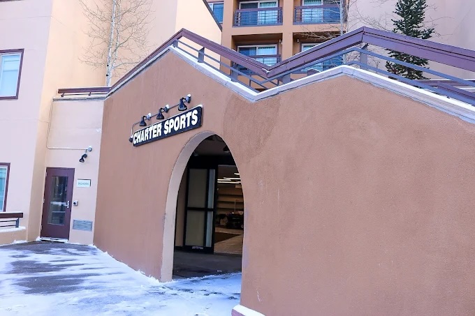 Charter Sports entrance at Marriott Mountain Valley Lodge in Breckenridge, Colorado, featuring a prominent sign and snow-covered pathway, emphasizing ski and snowboard rental services.
