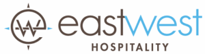 East West Hospitality logo featuring a stylized compass design and the words "east west" in brown and blue, representing a trusted lodging partner for Charter Sports' ski and bike rentals in Colorado.